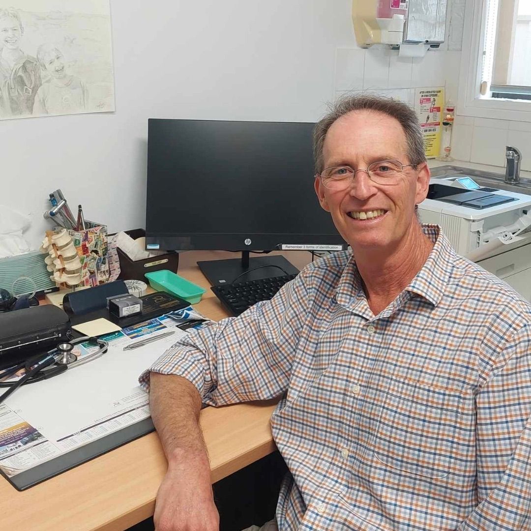 Dr Guy Laden - GP Doctor sitting in his office