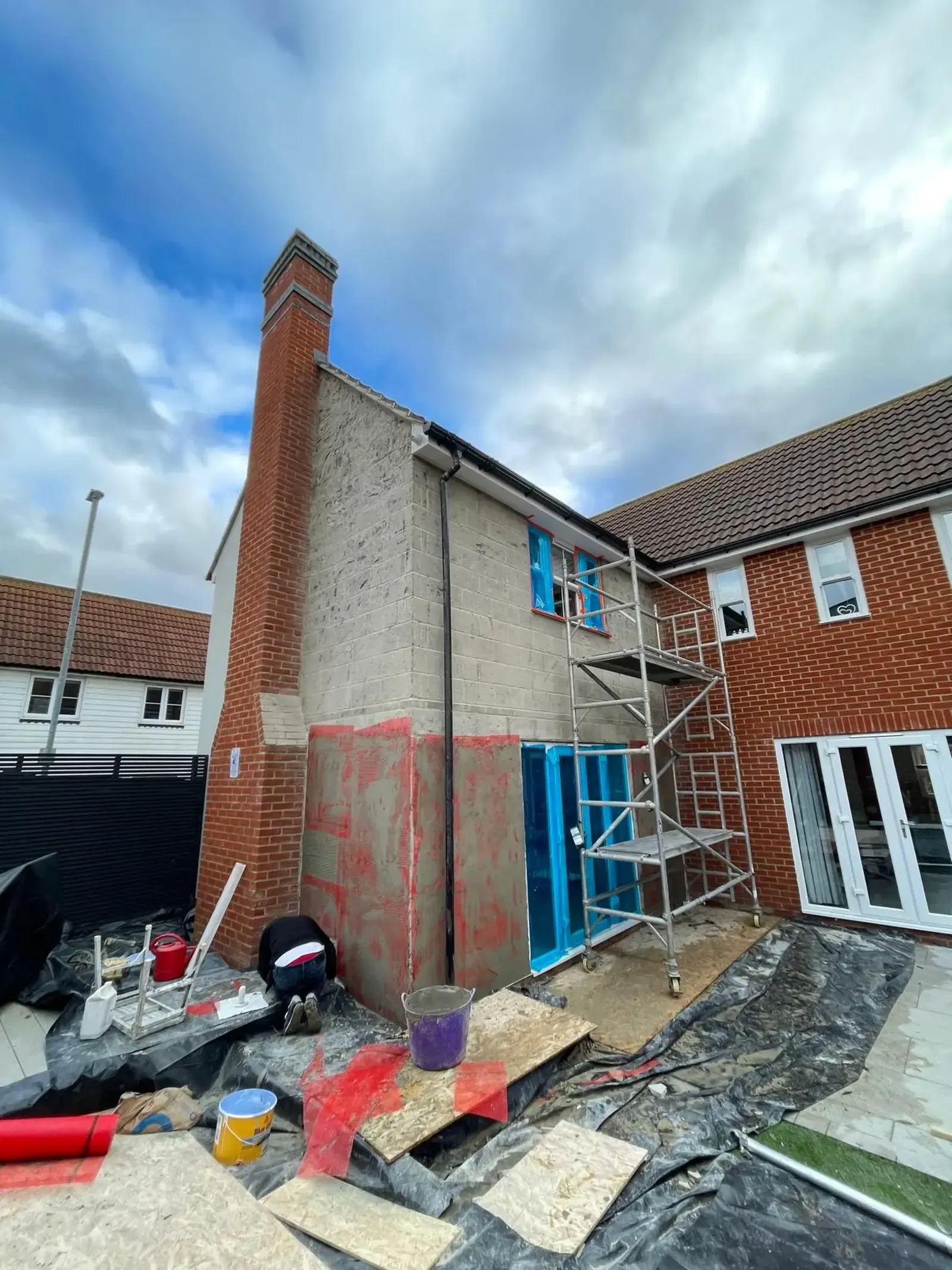 Hollow and loose render hacked-off in Great Dunmow, Essex