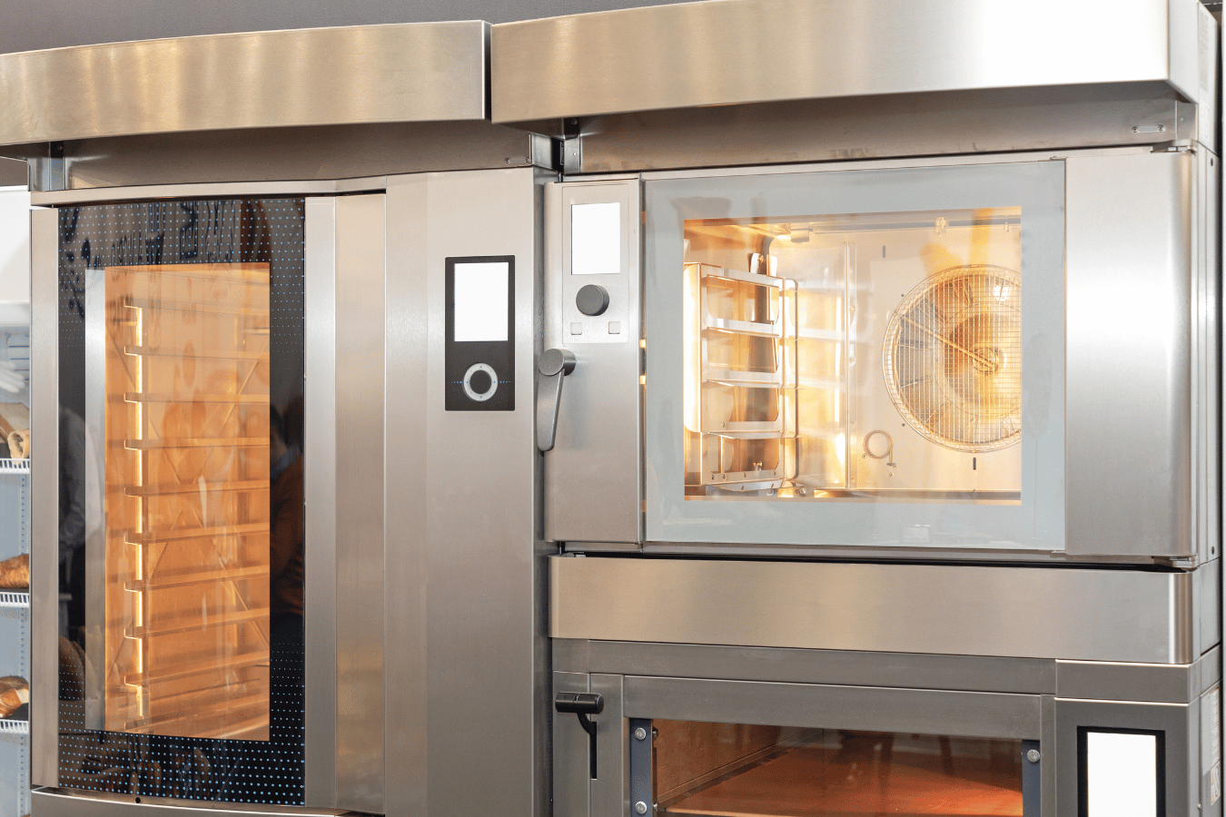 A stainless steel oven is sitting next to another oven in a kitchen.