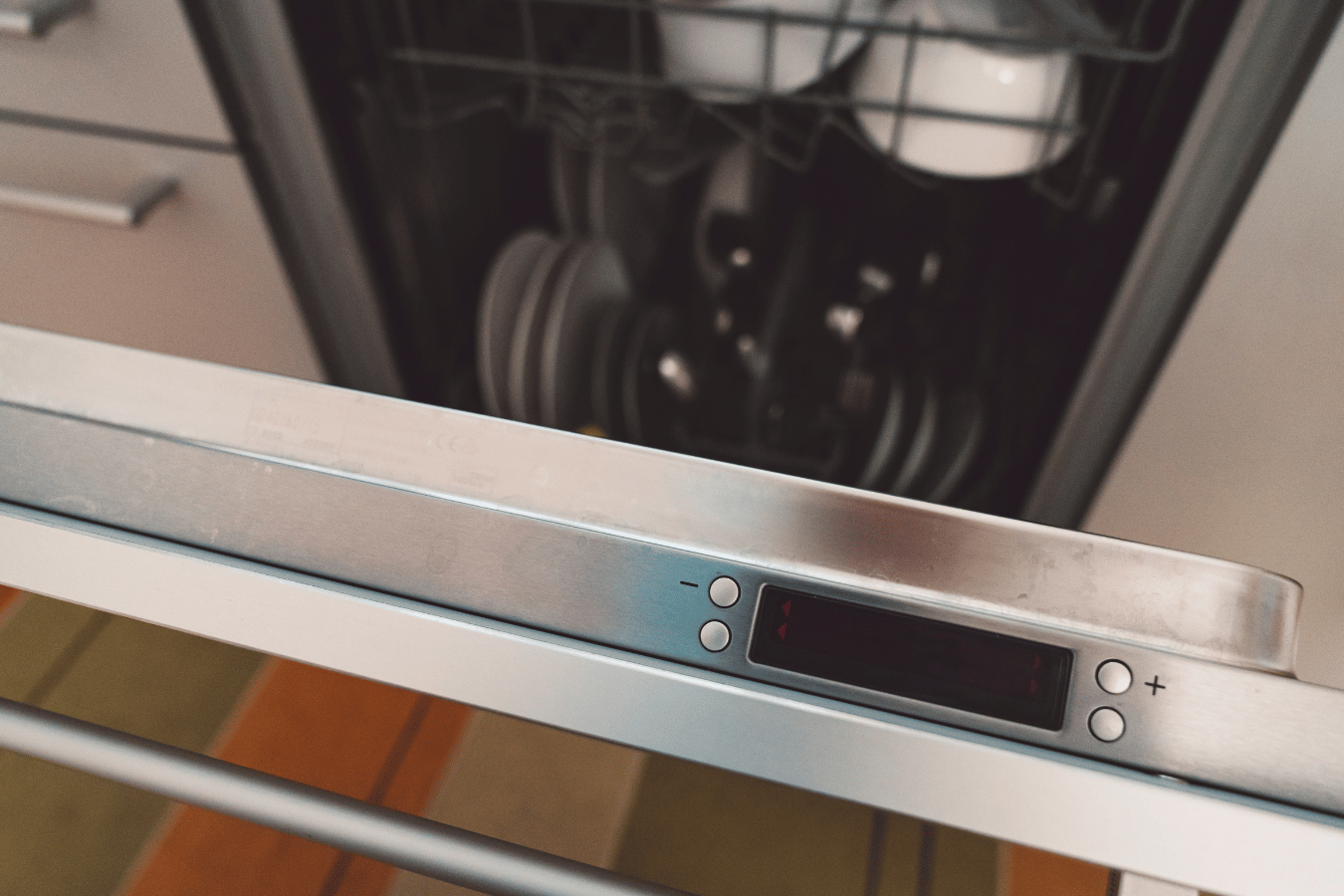 A close up of a dishwasher with the door open