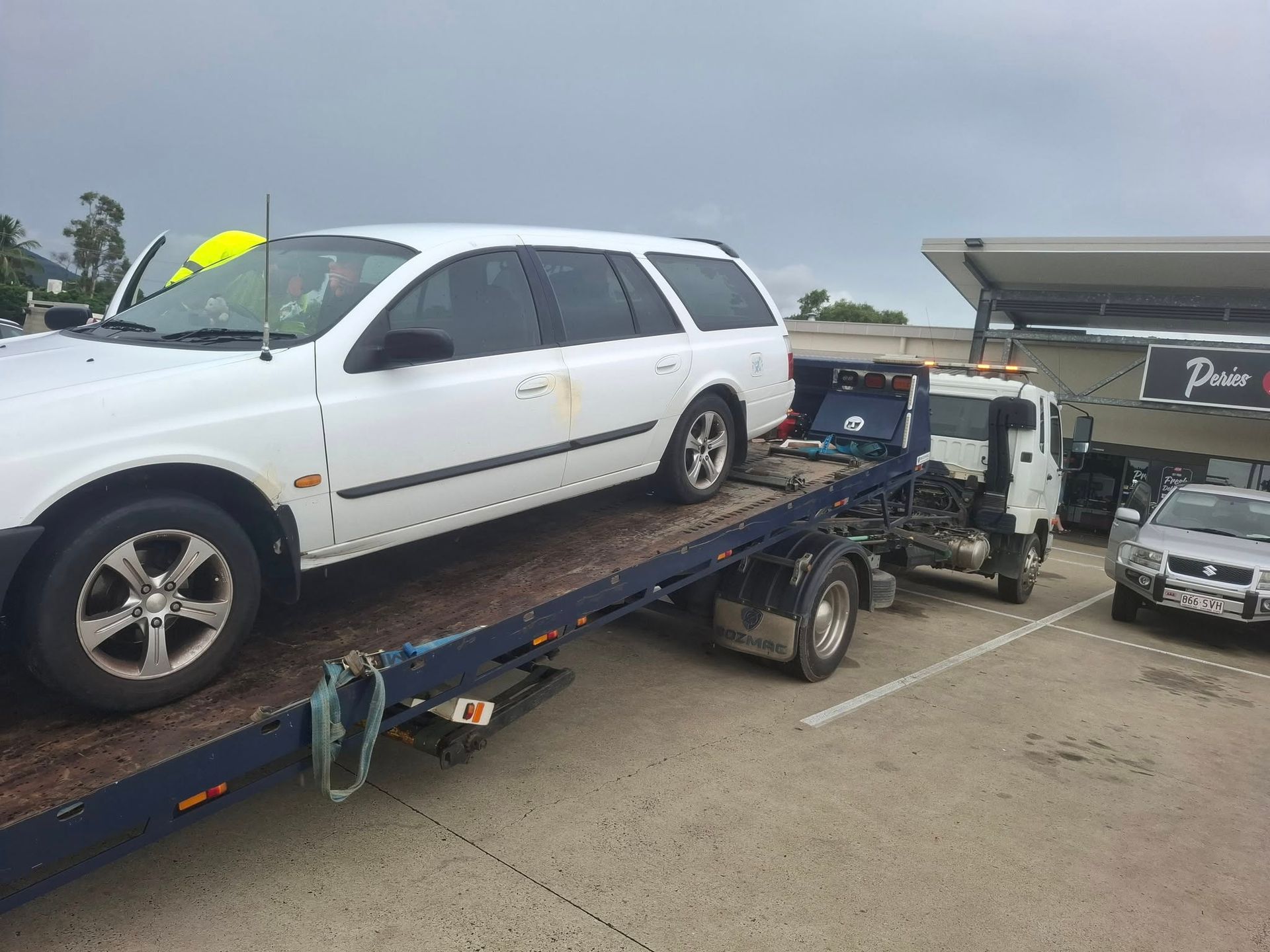 A Tow Truck Is Towing A Car — Rockhampton Towing And Transport in Gracemere, QLD