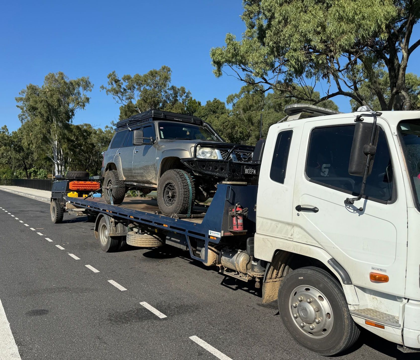 A Car Is Being Towed By A Tow Truck  — Rockhampton Towing And Transport in Gracemere, QLD