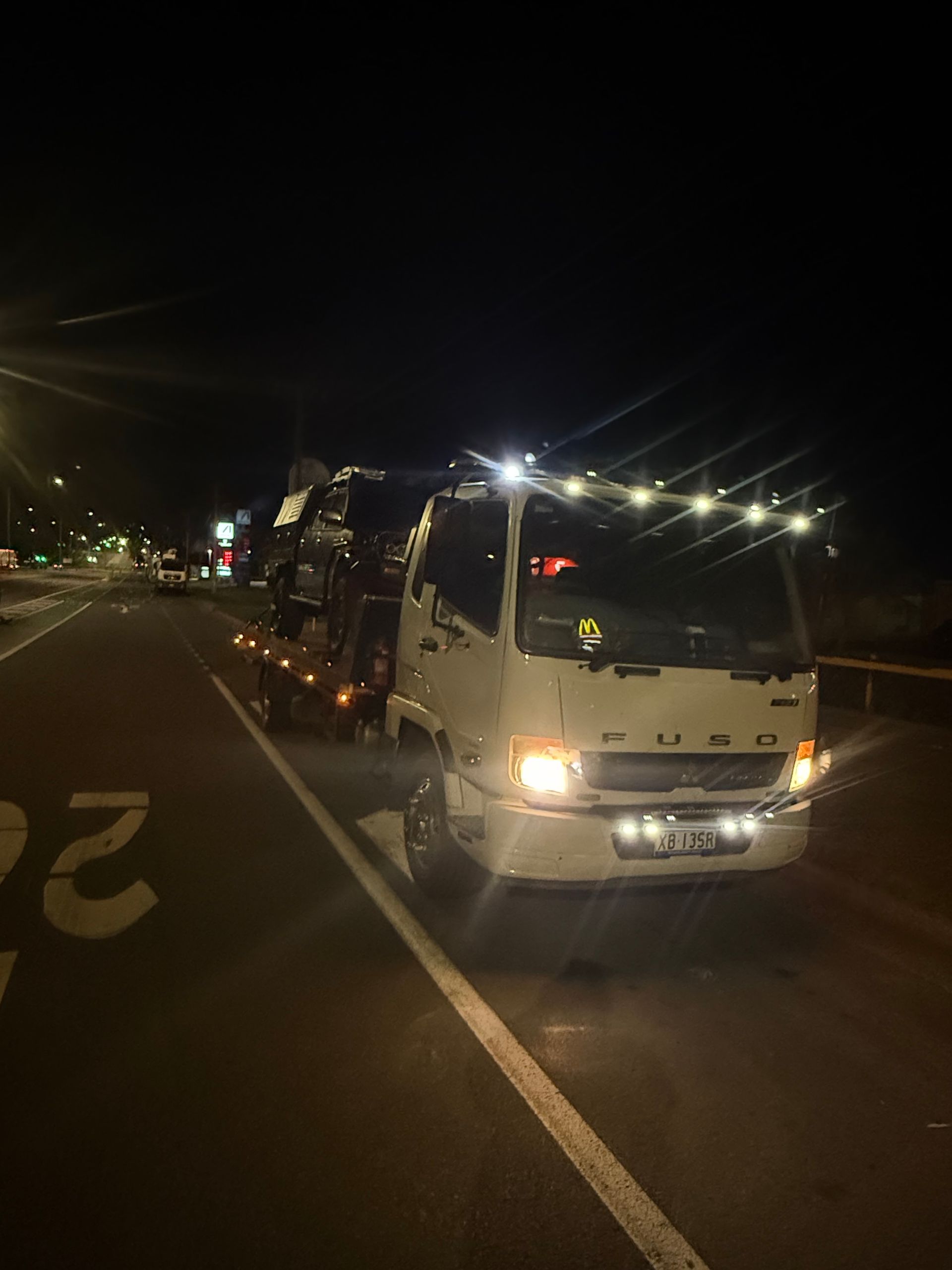 A Car Is Being Towed By A Tow Truck — Rockhampton Towing And Transport in Gracemere, QLD