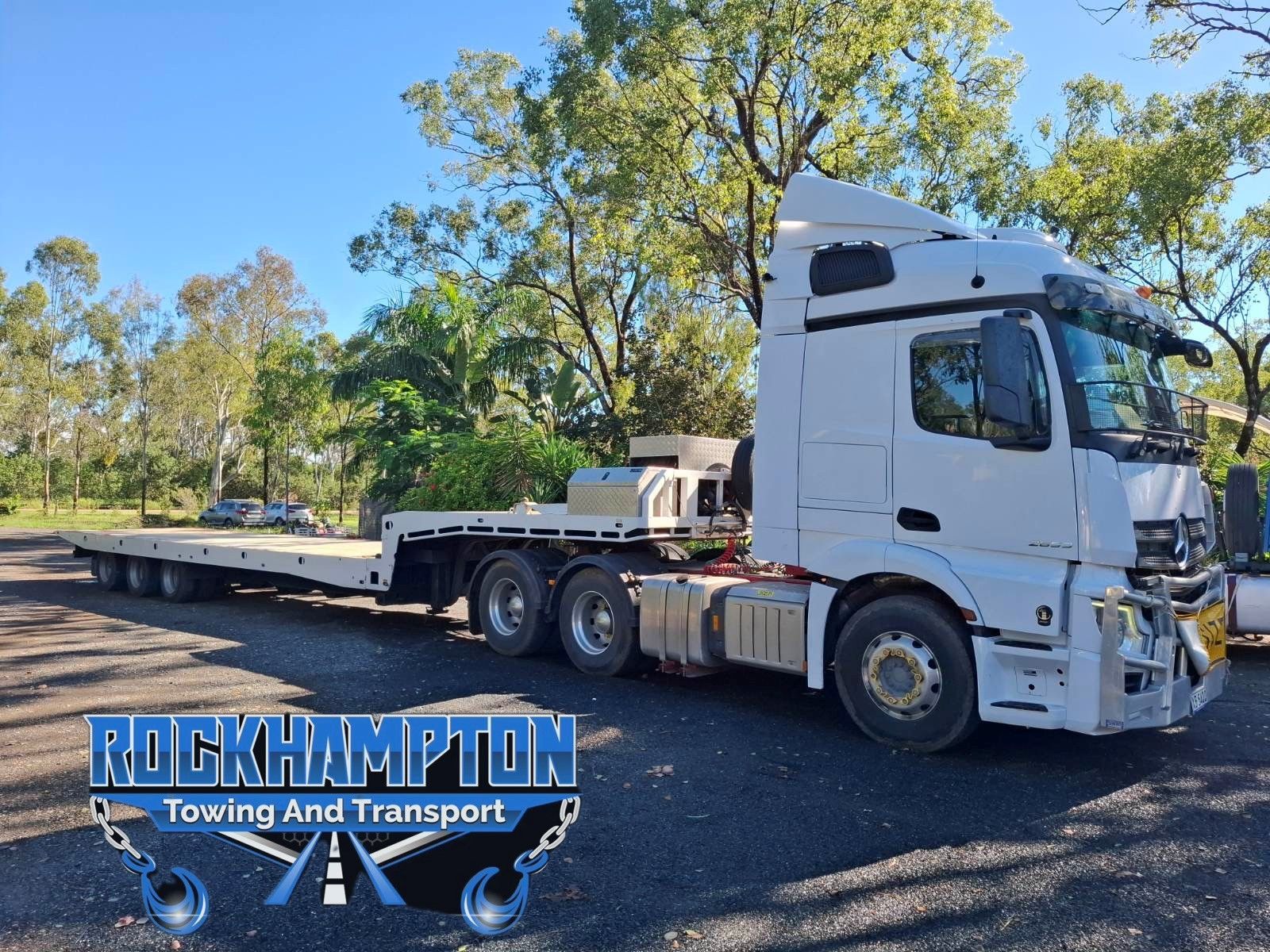 A Tow Truck Is Towing A Car  — Rockhampton Towing And Transport in Gracemere, QLD