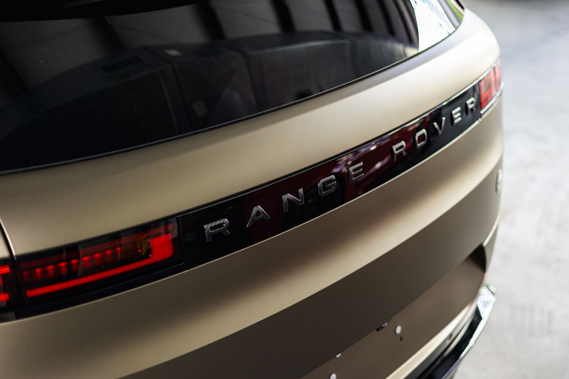 The rear end of a range rover is shown in a close up.