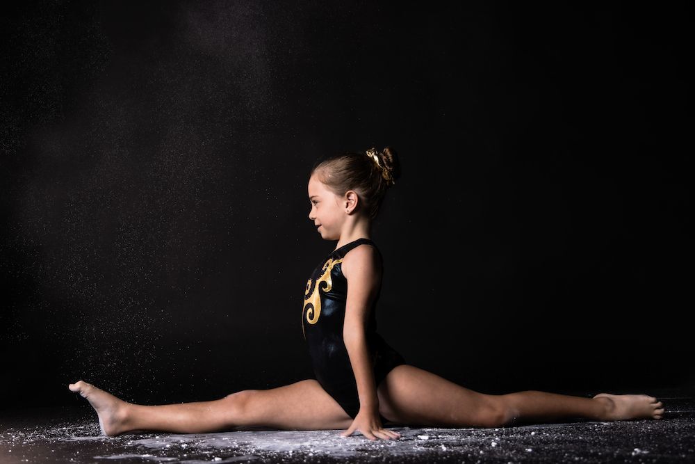 Young Gymnast Girl Splitting — Gold Medal Gymnastics In Gold Coast, QLD