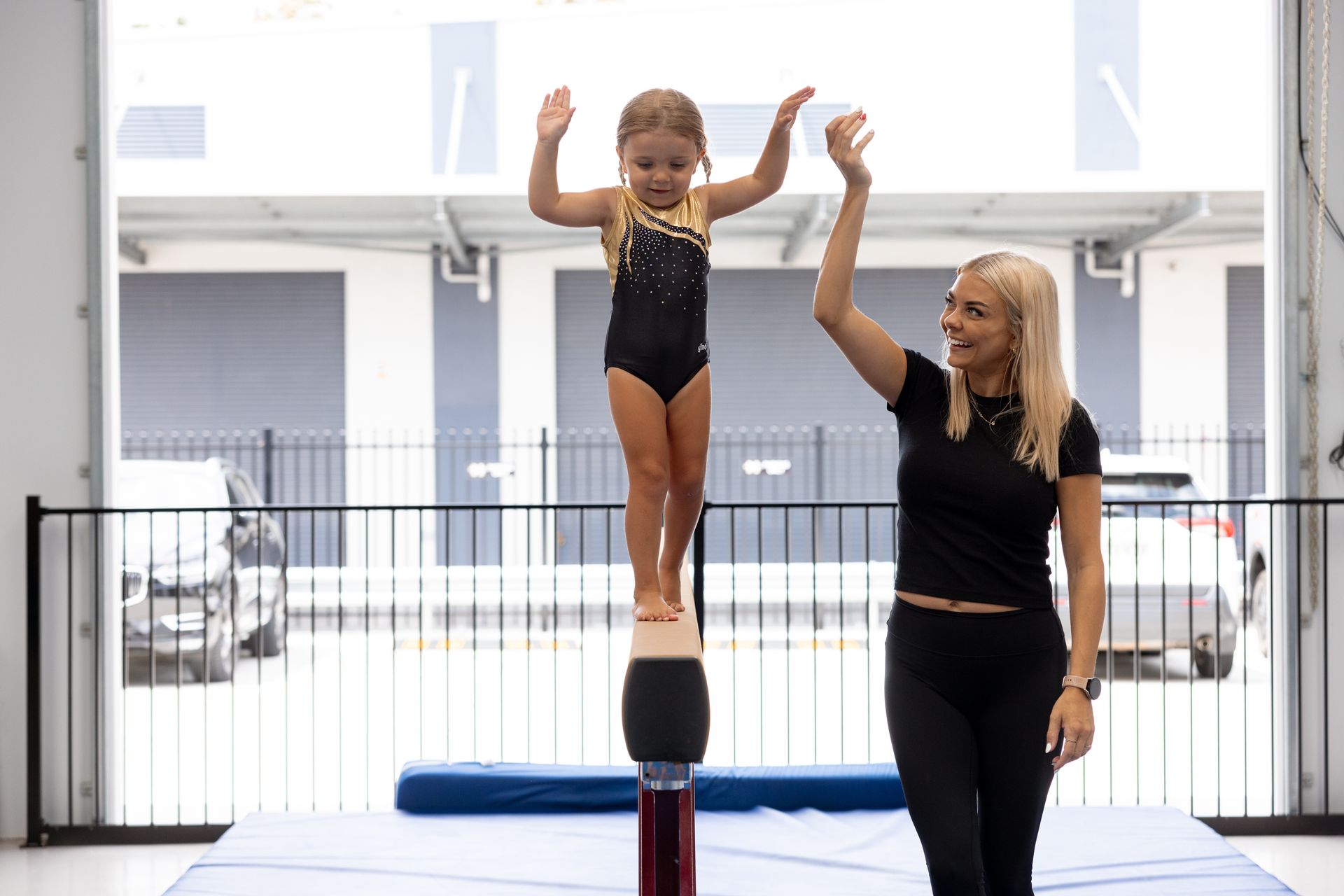A Man And Two Little Girls Are Playing With A Green Hula Hoop — Gold Medal Gymnastics In Gold Coast, QLD
