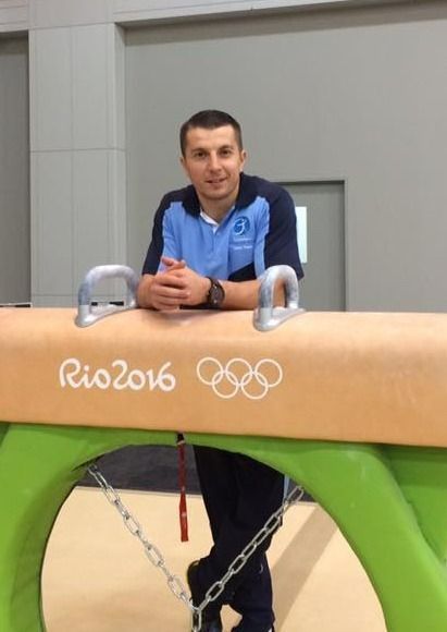 A Man Is Standing Next To A Rio 2016 Gymnastics Equipment — Gold Medal Gymnastics In Molendinar, QLD