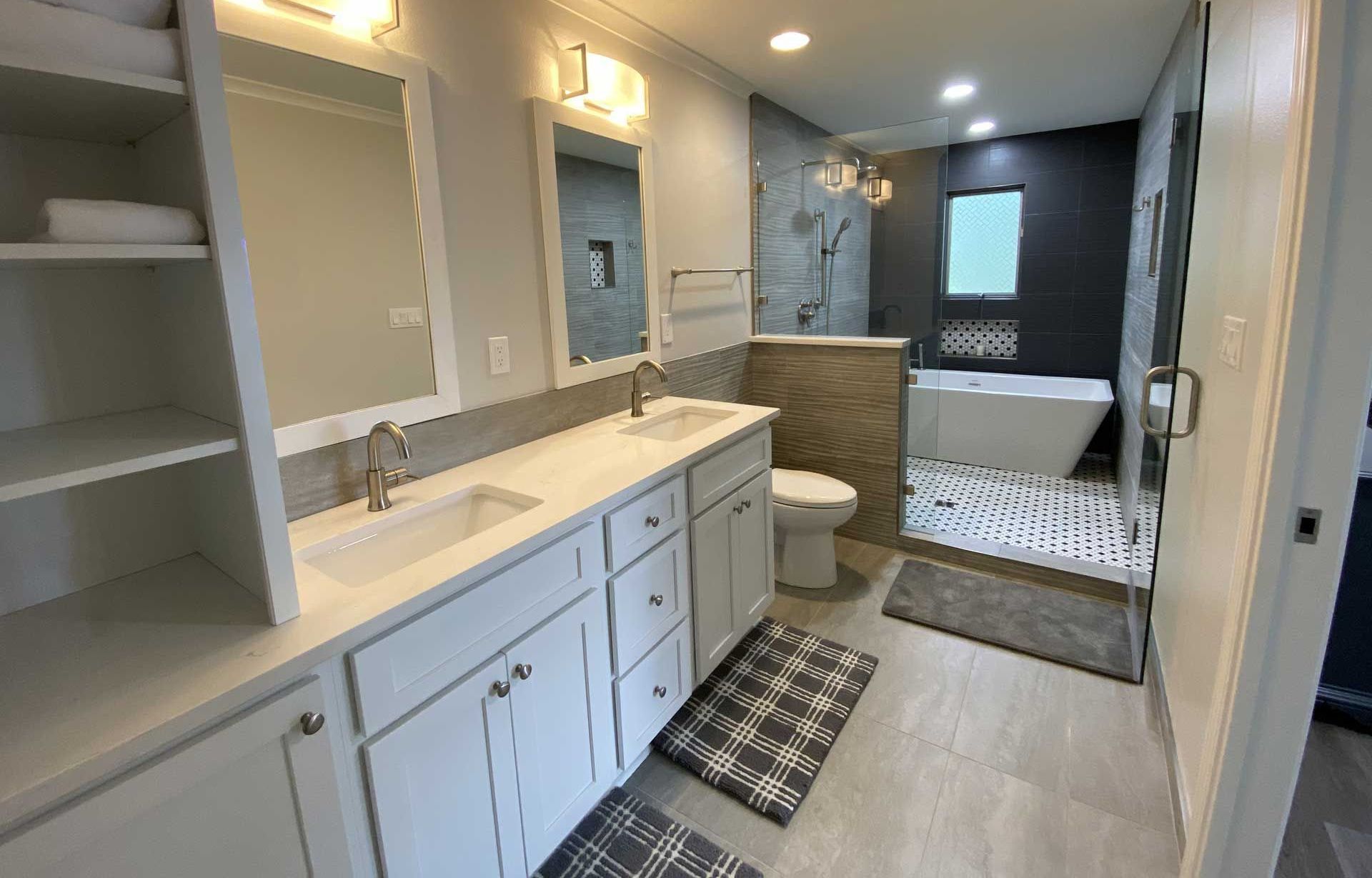 A bathroom with two sinks , a toilet , and a bathtub.