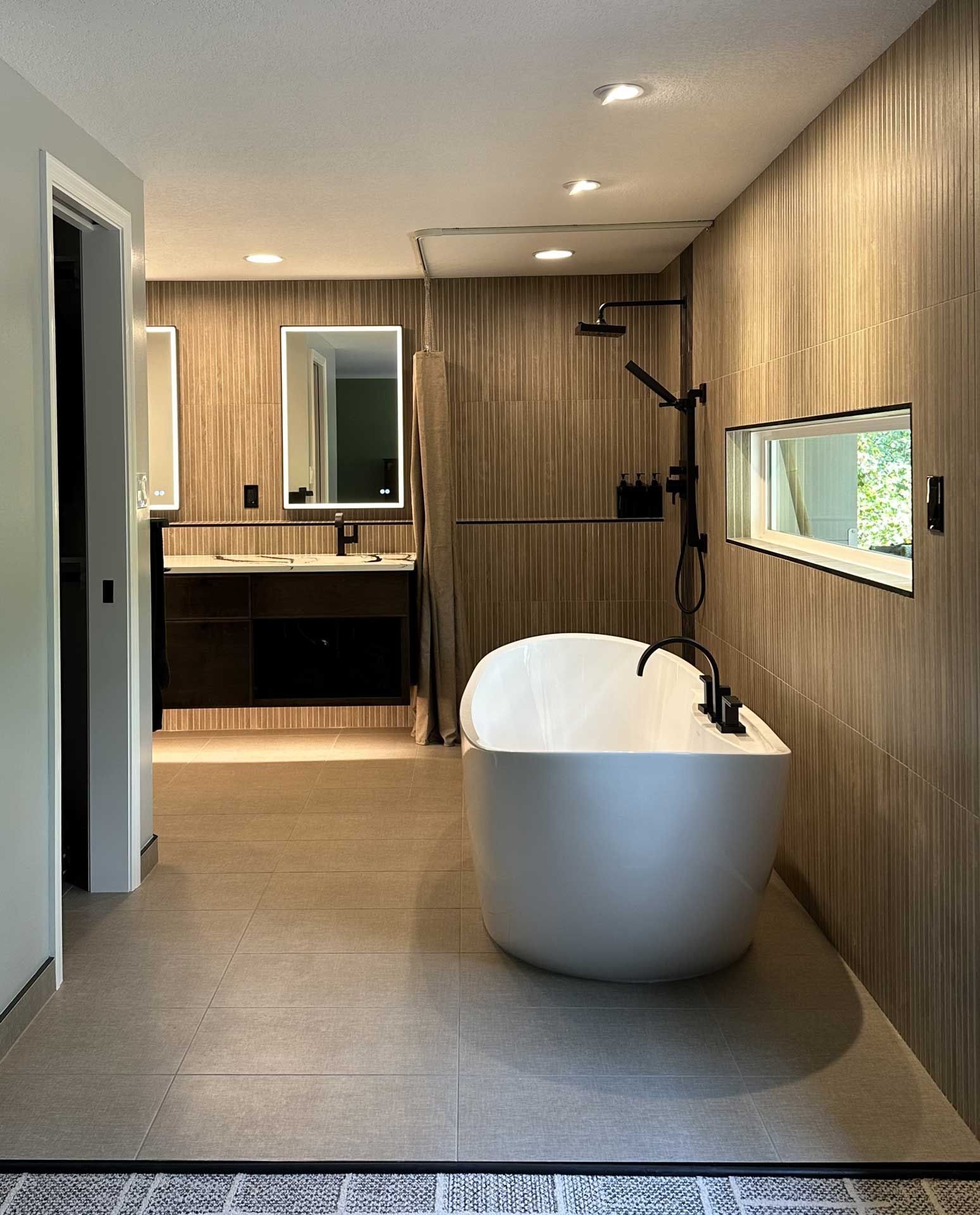 A bathroom with a bathtub and two sinks