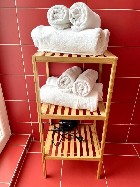 White towels on a wooden shelf in a bathroom