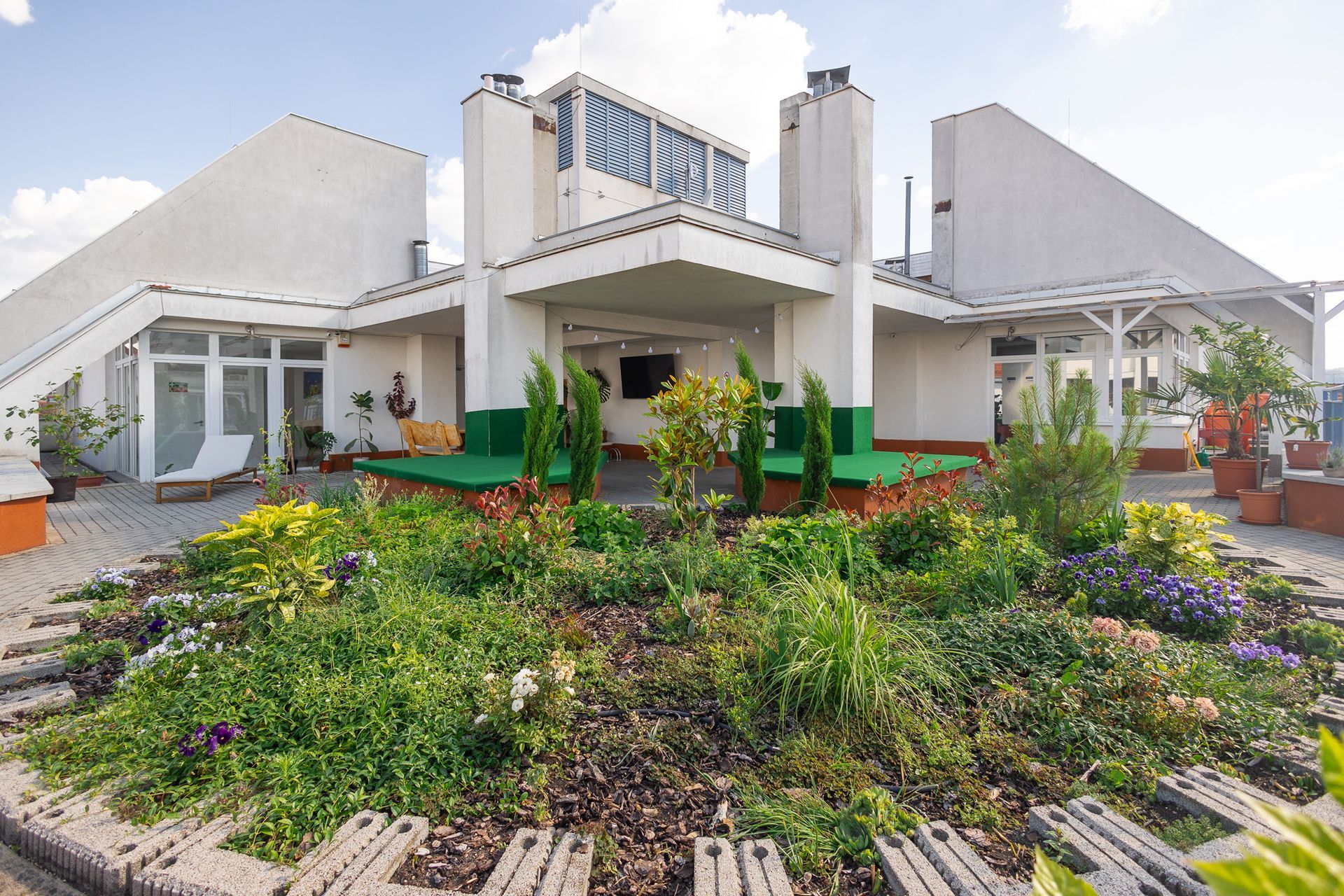 A large white house with a garden in front of it