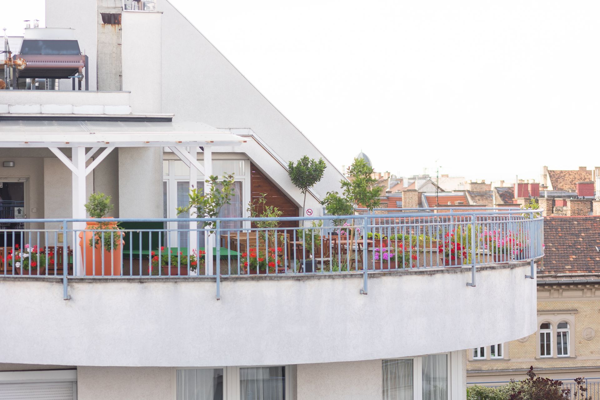 A balcony with lots of potted plants on it