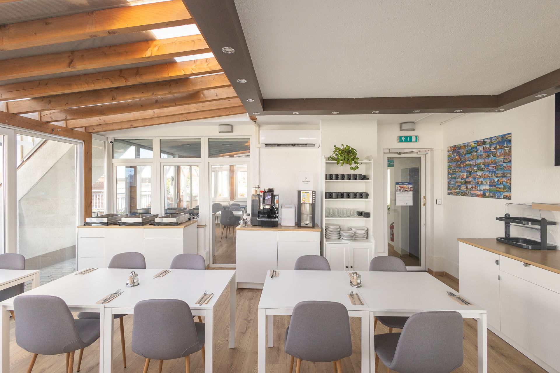 There are many tables and chairs in the room.