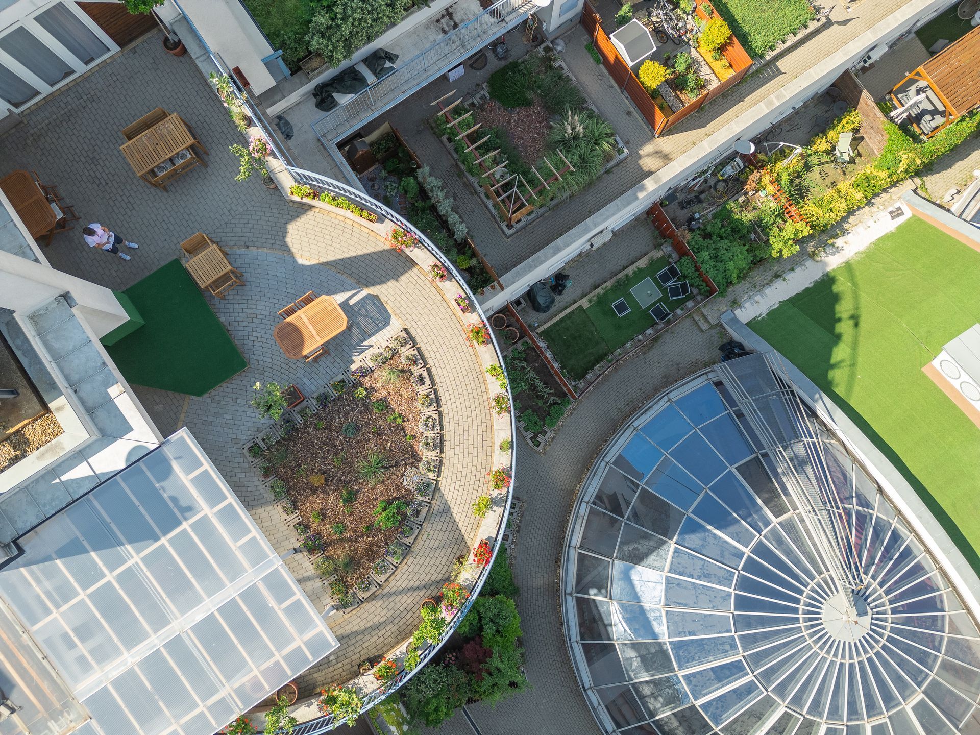 An aerial view of a building with a circular rooftop garden.