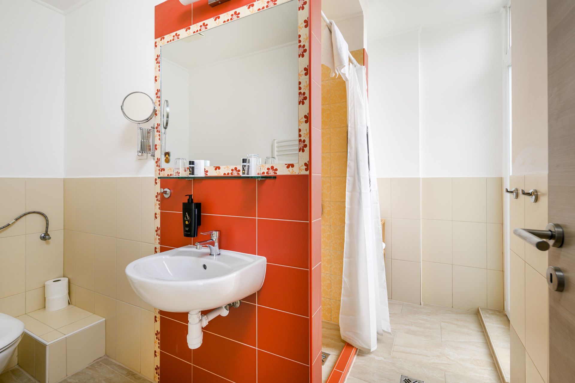 A bathroom with a sink , mirror and toilet.