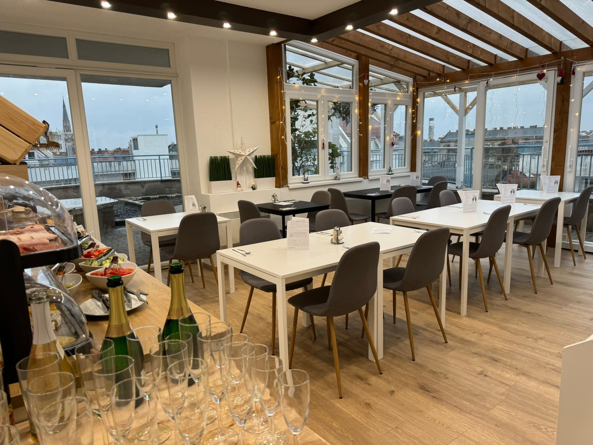 A restaurant with tables and chairs and bottles of wine on the counter.