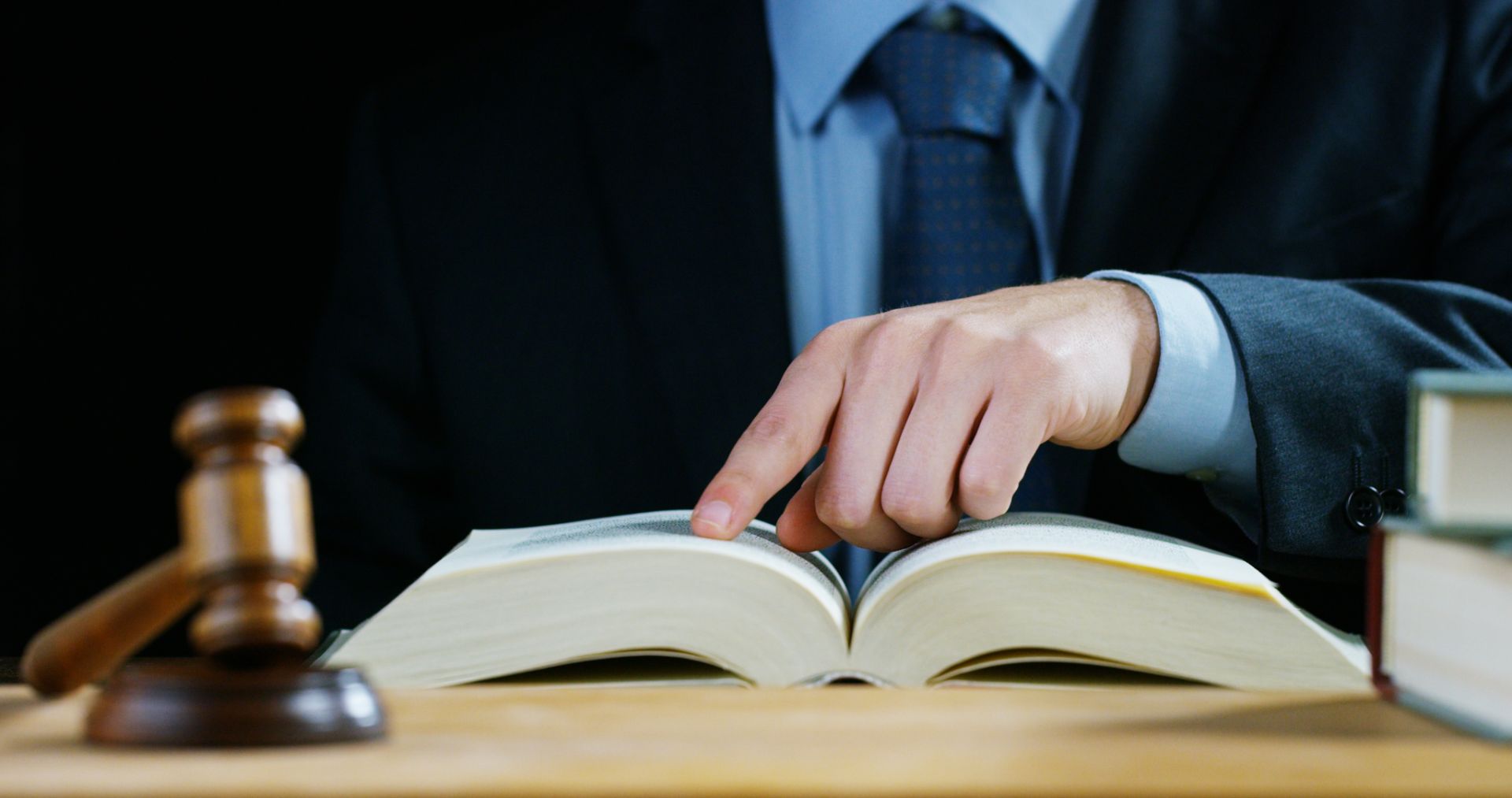 A person pointing to a page in a book