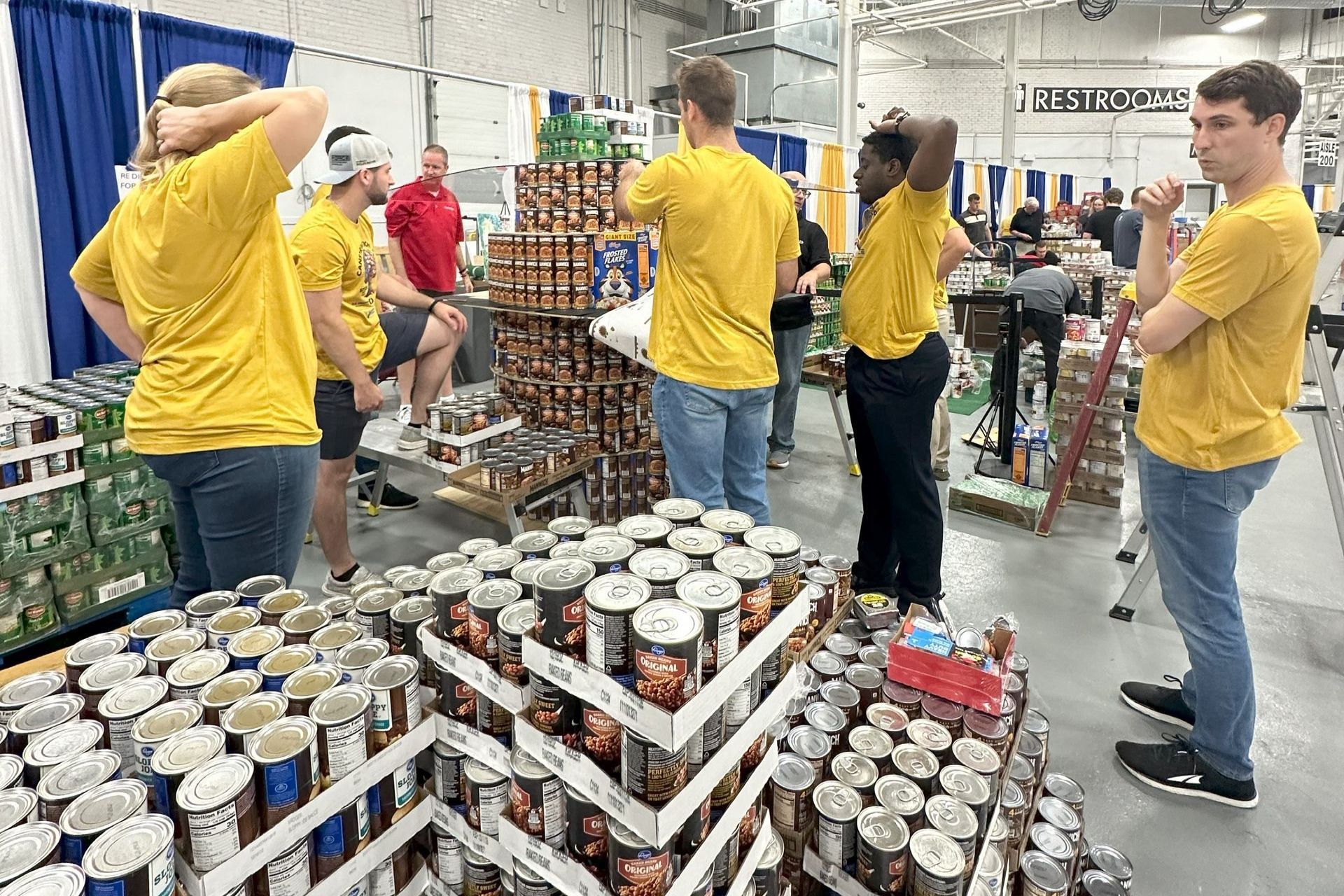 A photo showing team members from Force Construction and RE Diamond building a structure from food items.