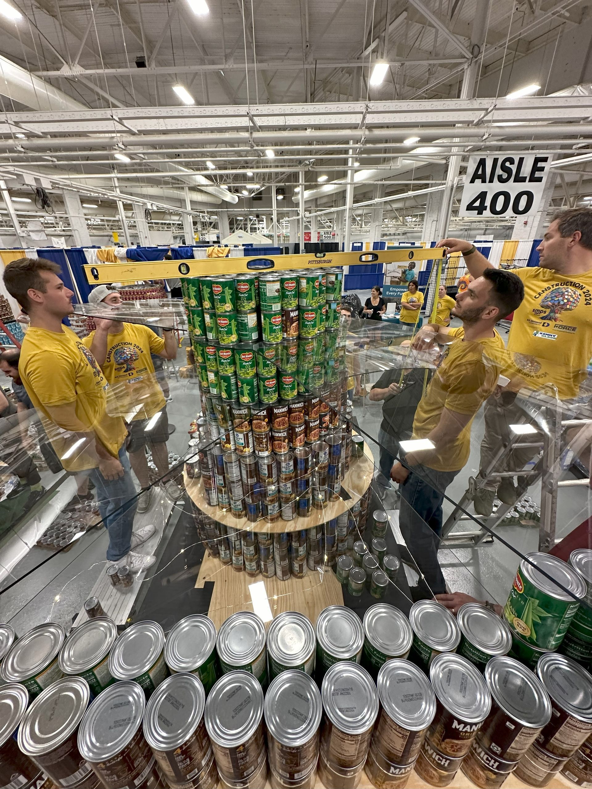 Force team members building a structure for the CANstruction event.