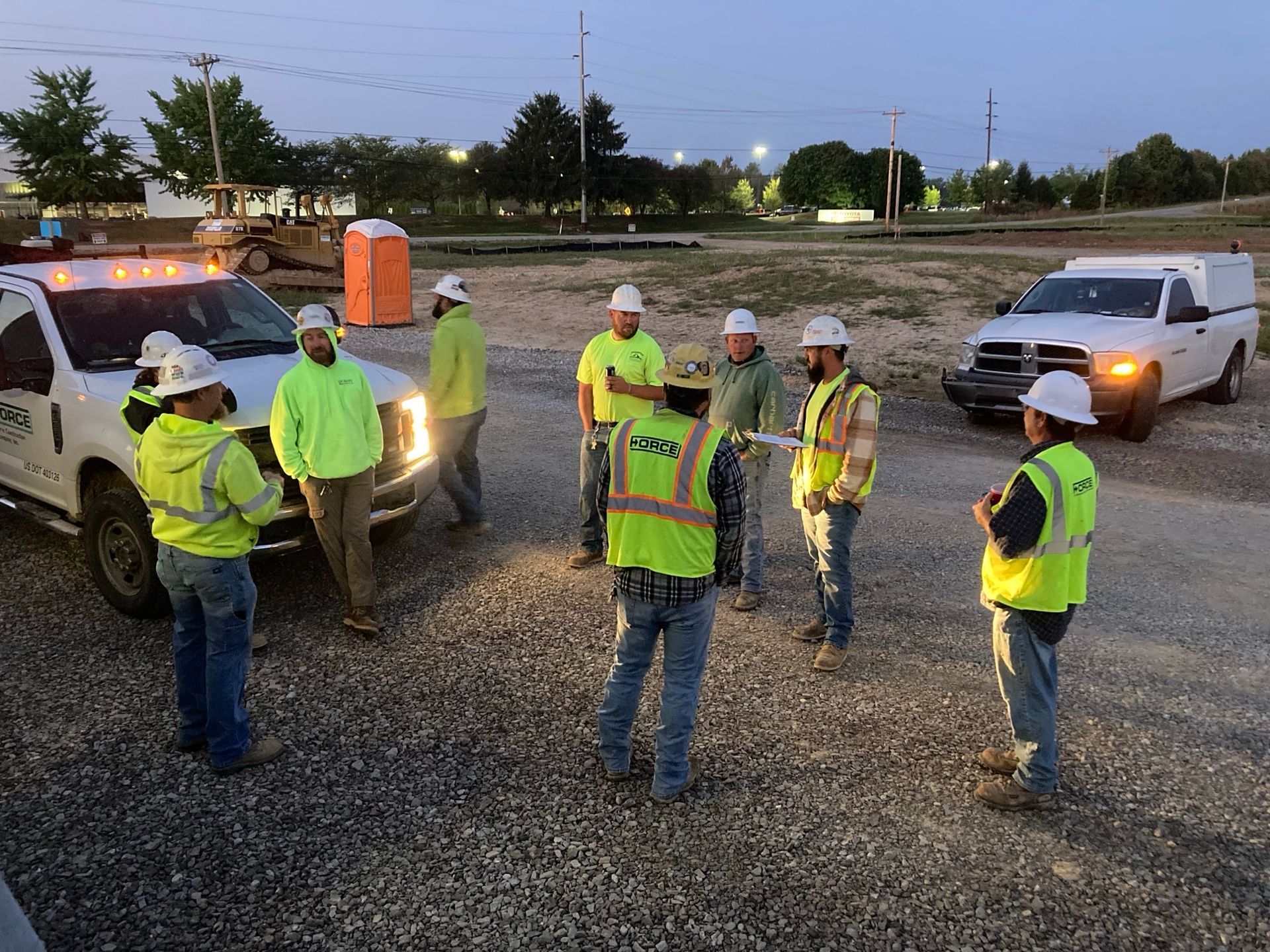 A group of Force Construction employees gather for a morning 