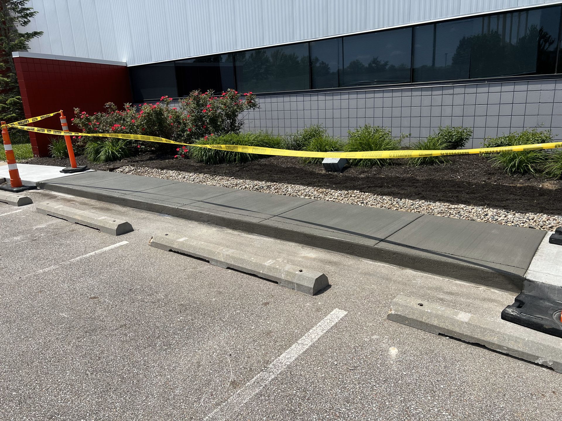 A concrete sidewalk is being built in front of a building.