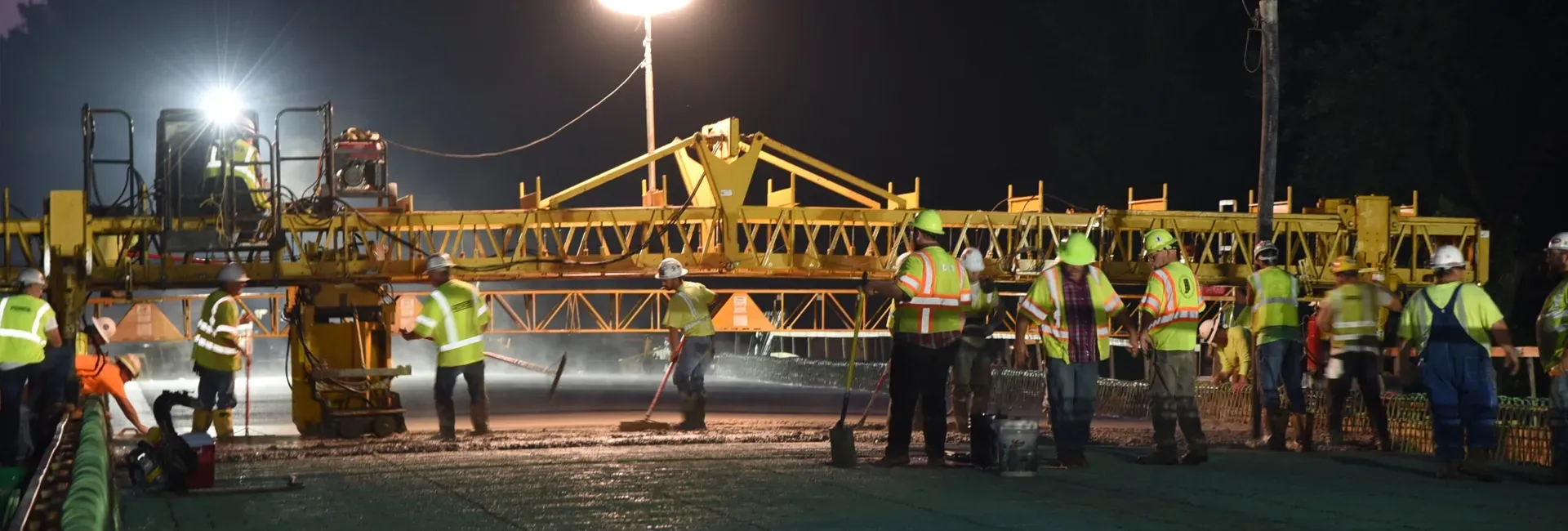 A group of Force Construction employees pours concrete for a bridge