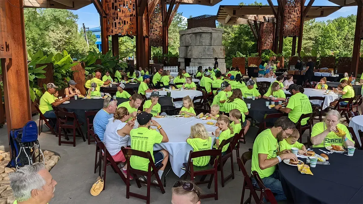 Photo of Force employees and their families eating lunch at the Indianapolis Zoo.