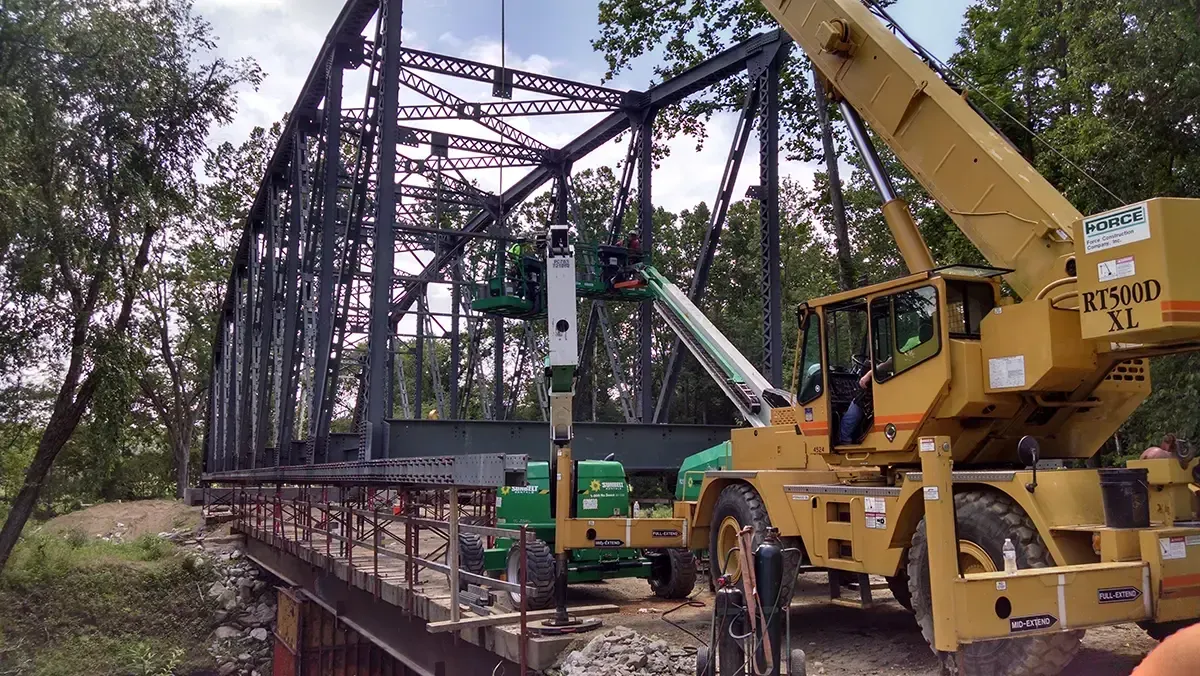 Force Construction crews lifting an entire steel bridge off it's foundations.