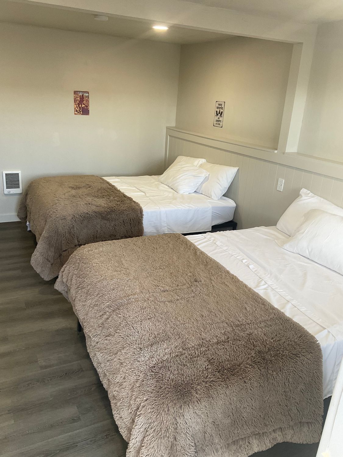 There are two beds in a hotel room.