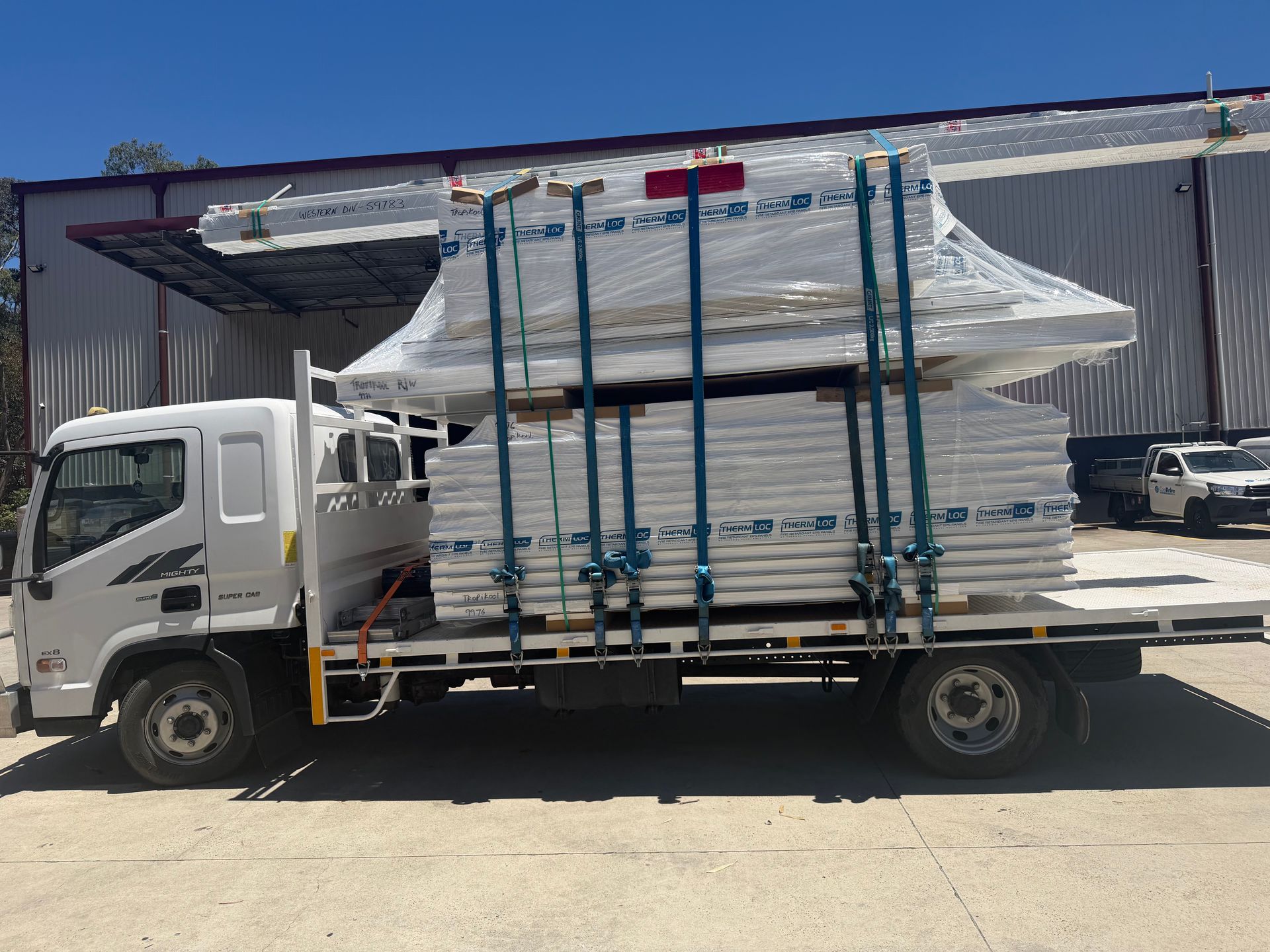 Stacked fire-resistant white drywall sheets for construction and interior wall installation.