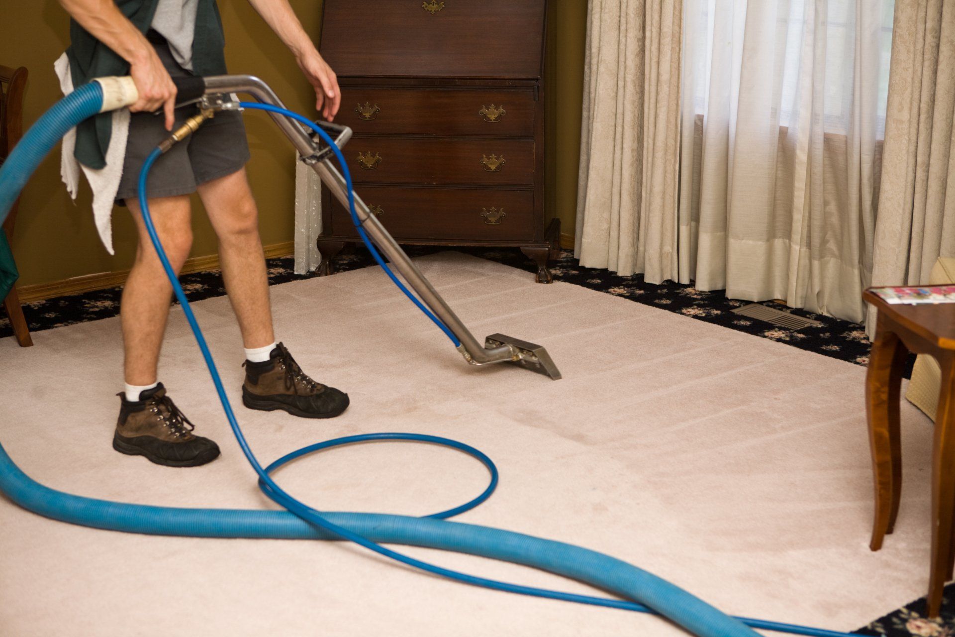 Man Vacuuming The Carpet Of An Office — Cheyenne, WY — Steam Power Inc