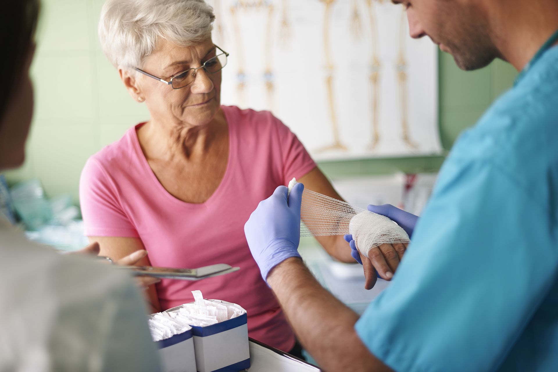 An elderly woman is getting an injection in her arm by a doctor.