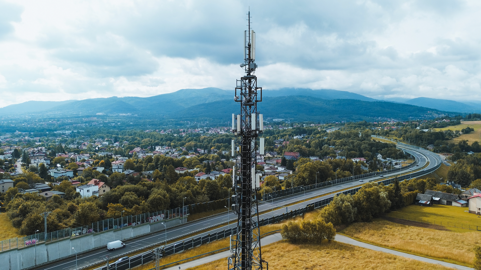 An aerial view of a cell phone tower in the middle of a field.