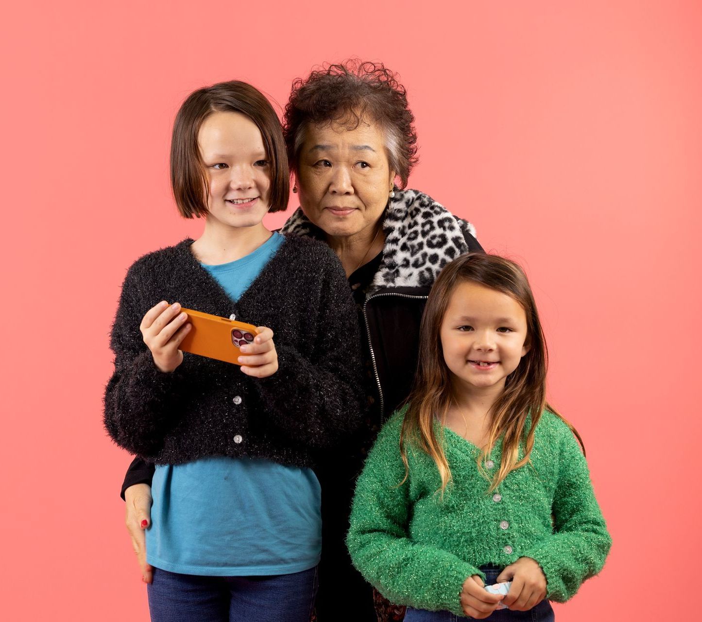 A grandma posed with her two granddaughter