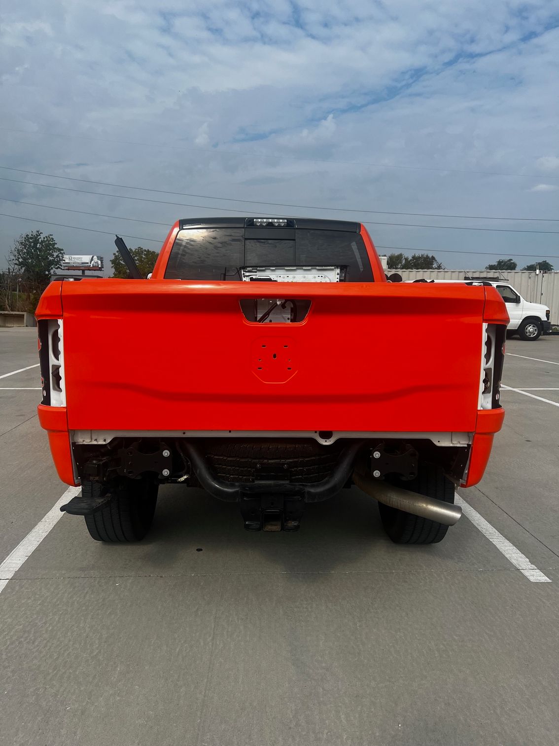 A red truck is parked in a parking lot.