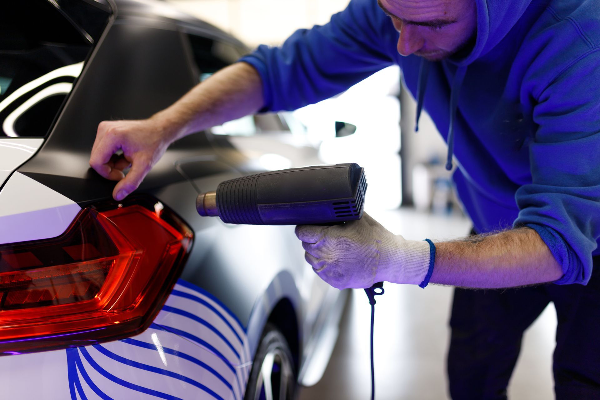 Man vinyl wrapping a car