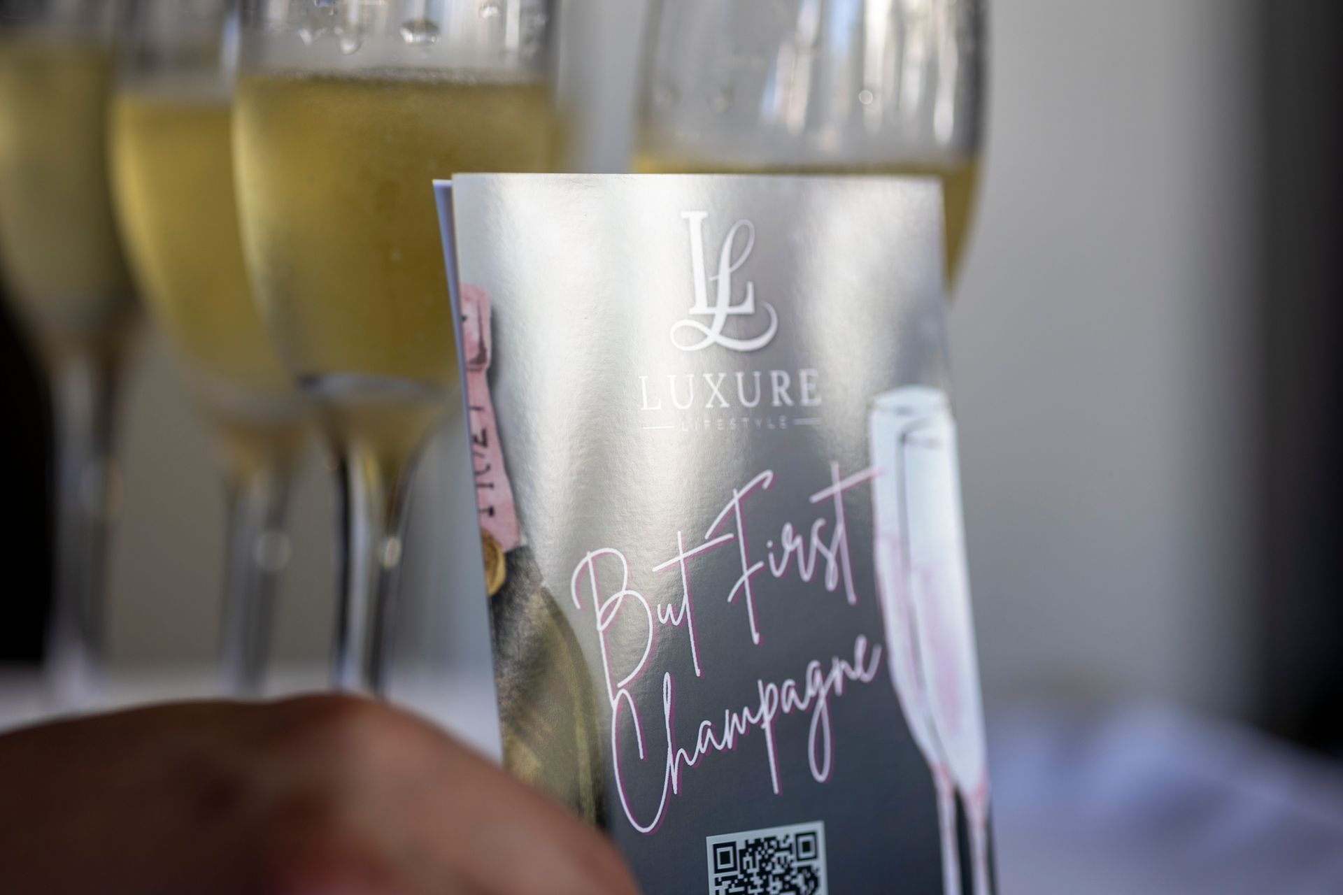 Champagne glasses behind a card that says,