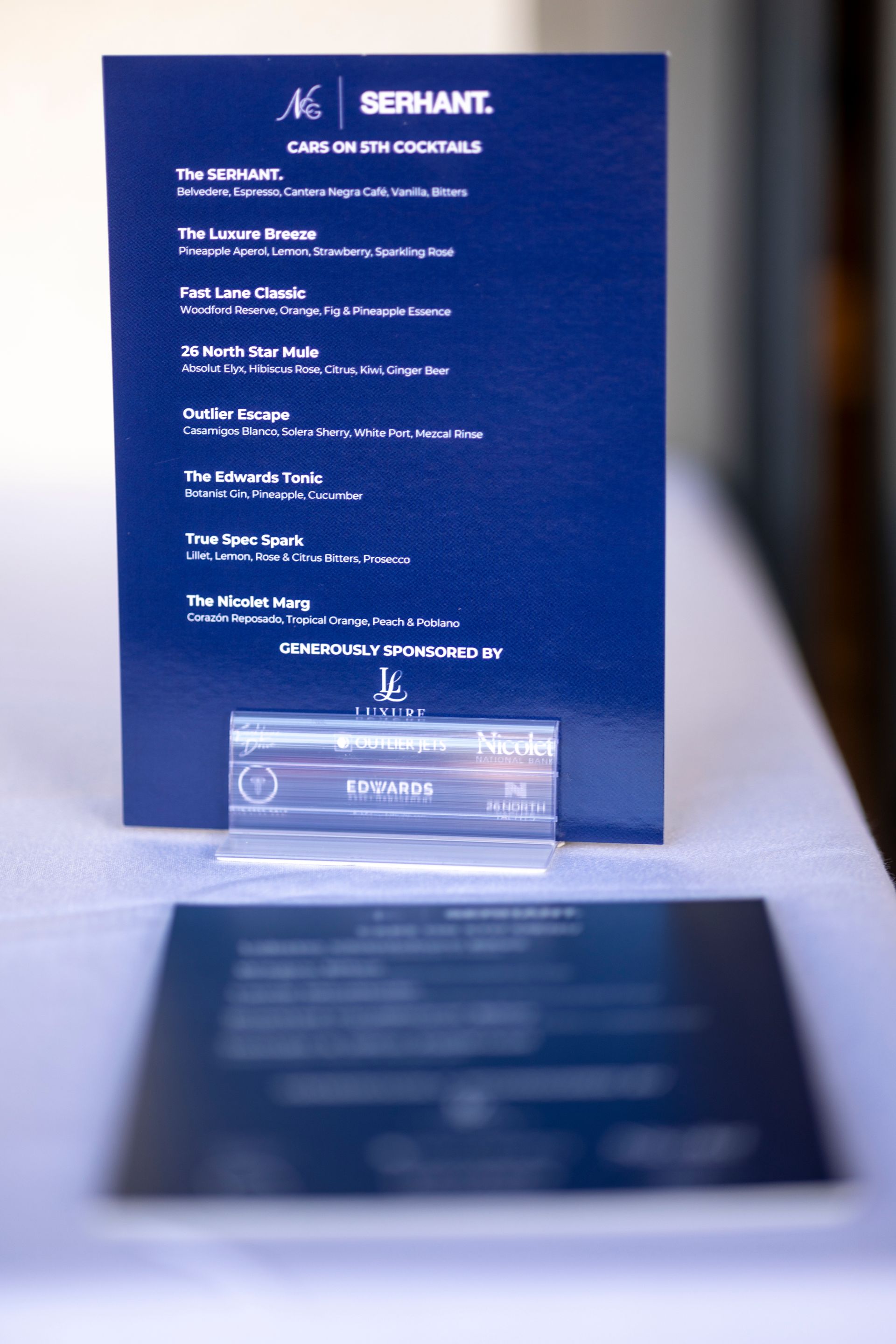 Blue menu card on a white table listing