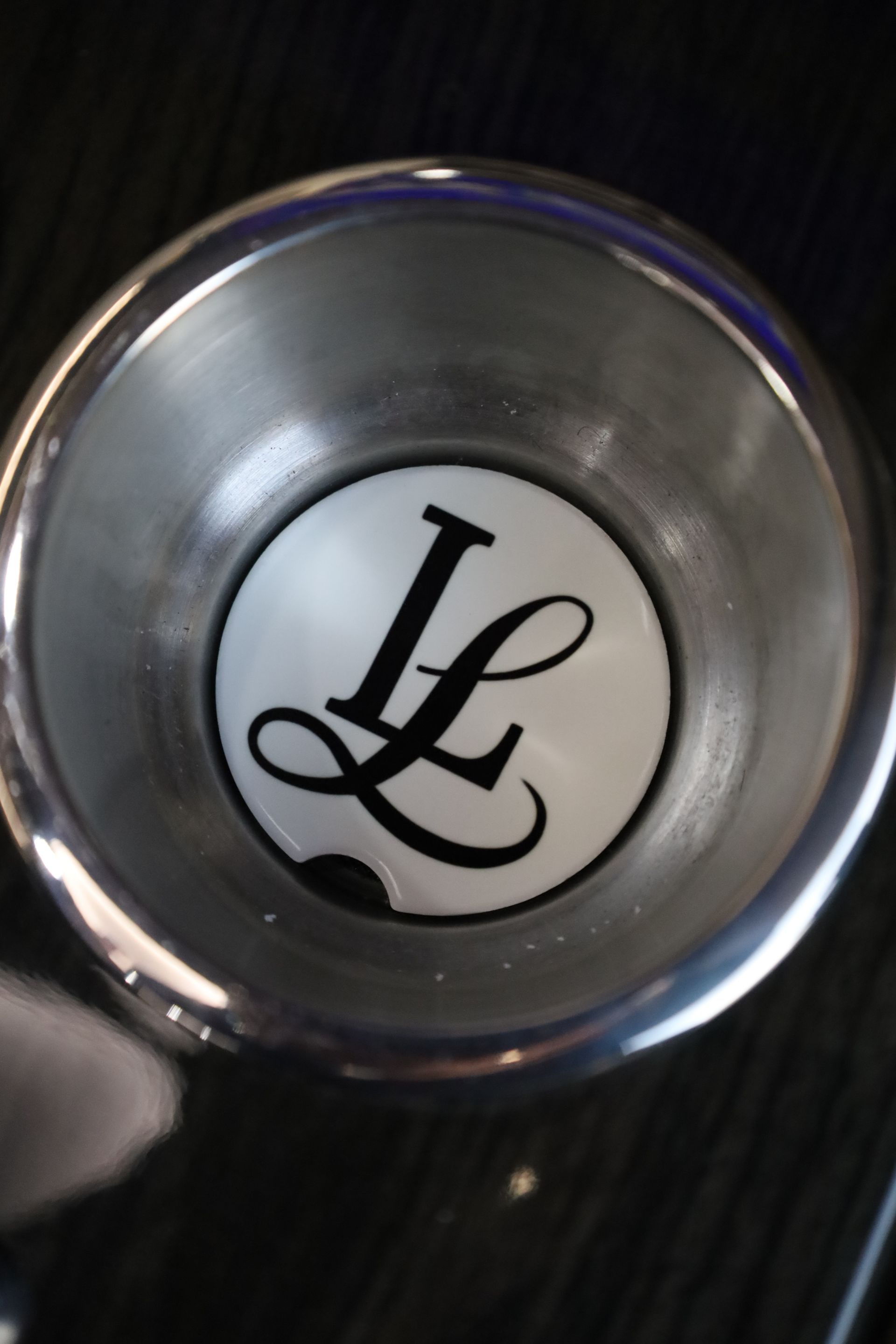 Silver cup with white bottom, black 