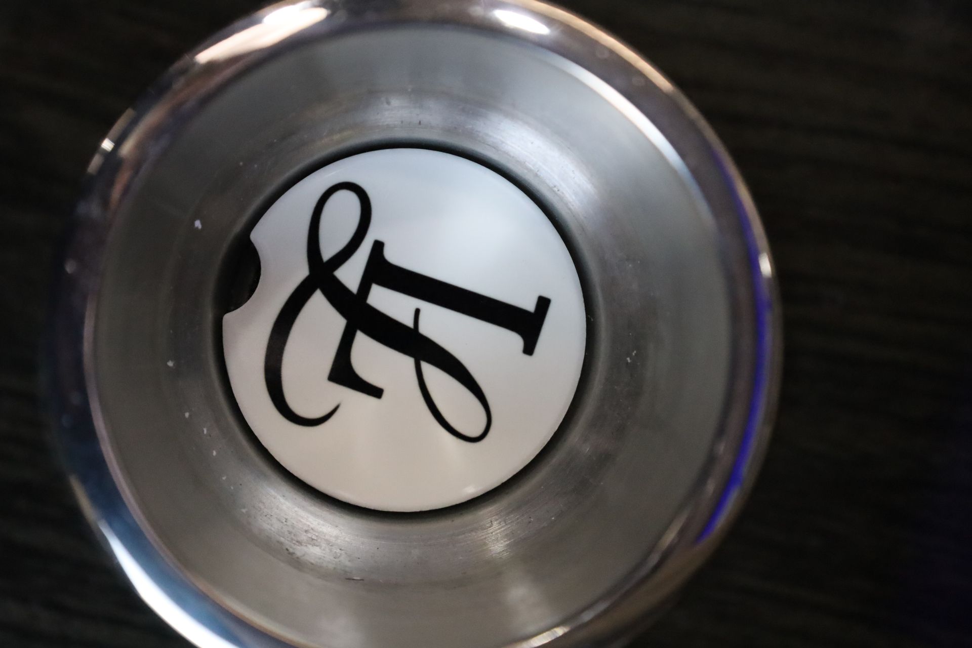 Silver tap with the letters 