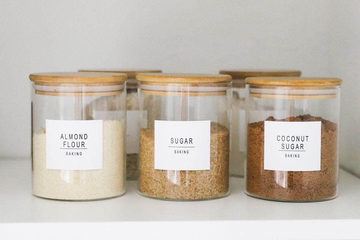 Glass jars of baking ingredients labeled 