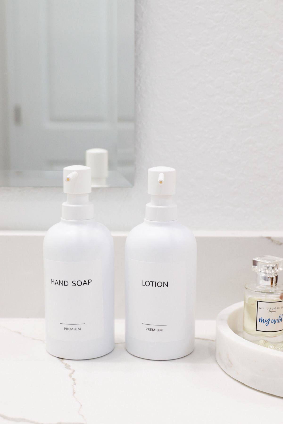 Two white soap dispensers labeled 