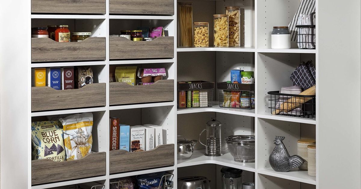 Corner pantry with white shelves and rustic wood-look drawers, filled with food items.