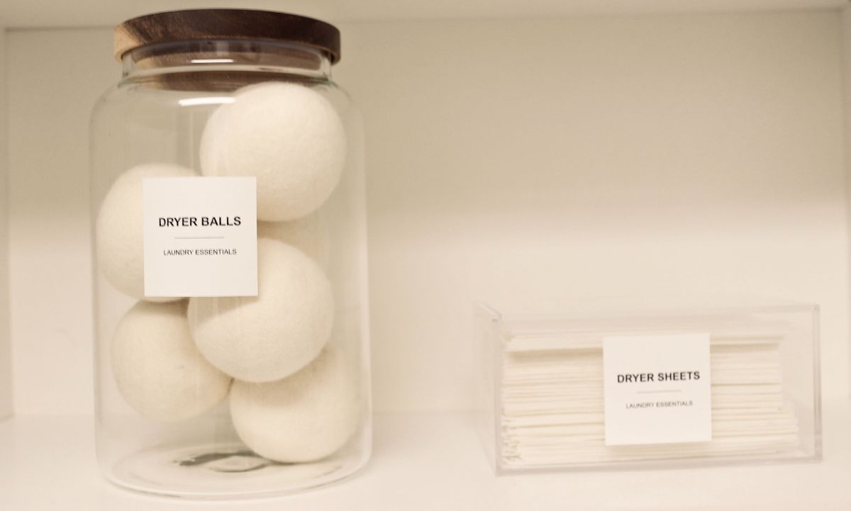 Glass jar with wooden lid holding white spheres; small box of white strips beside it.