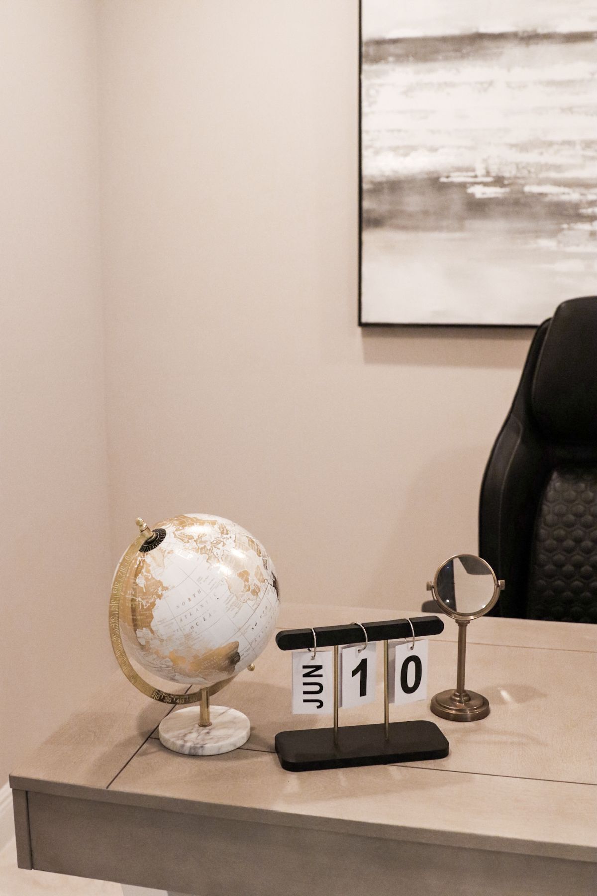 Desk with a globe, a perpetual calendar reading June 10, and a magnifying glass.