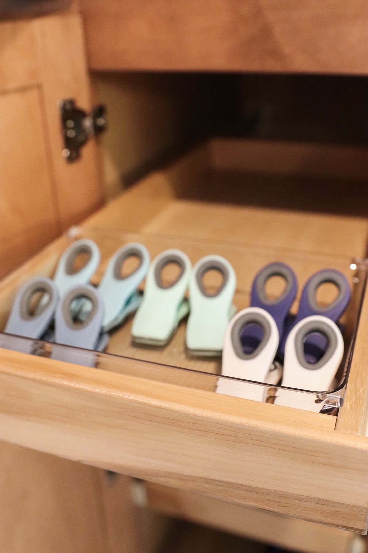 Drawer with multiple colored magnetic clips arranged in rows.