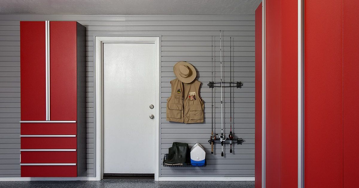 White garage storage cabinets with a black pegboard and countertop.