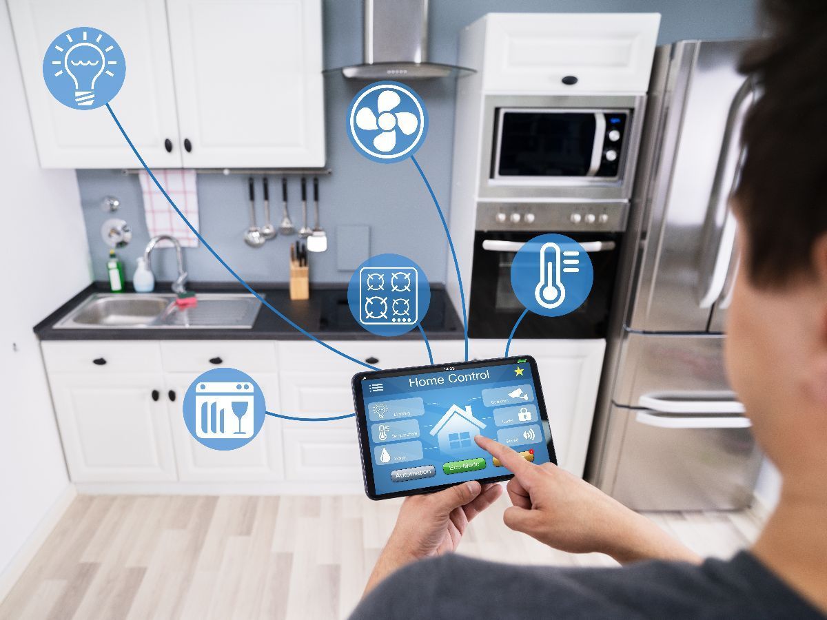 Stone steps lead up to a gazebo with a red tile roof and house. Green lawn and shrubs.