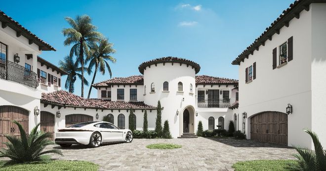 White luxury home with a car parked in front; palm trees and blue sky visible.